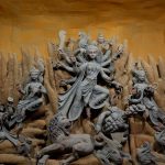 A stunning display of the Hindu goddess Durga with detailed sculptures, part of Durga Puja celebrations.