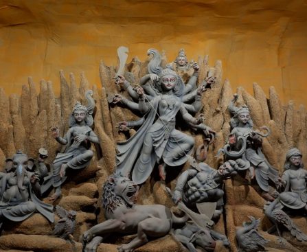 A stunning display of the Hindu goddess Durga with detailed sculptures, part of Durga Puja celebrations.