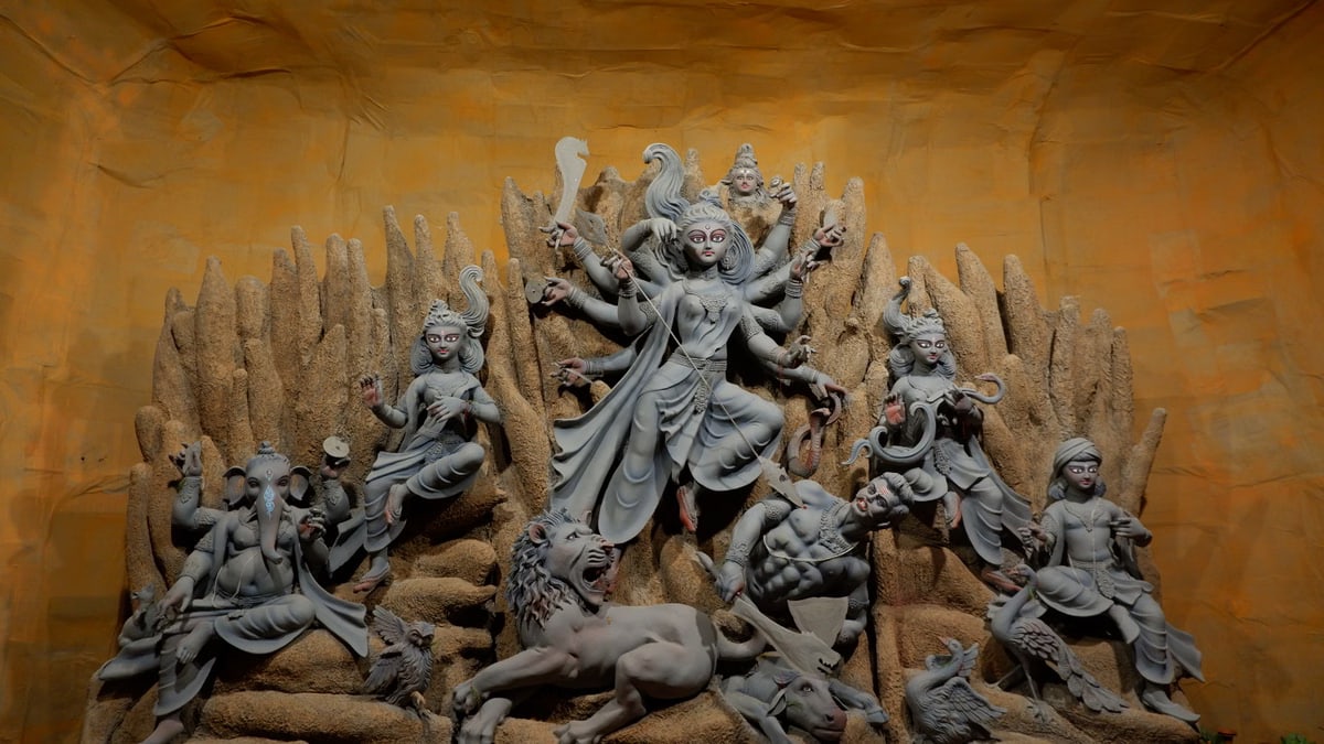 A stunning display of the Hindu goddess Durga with detailed sculptures, part of Durga Puja celebrations.